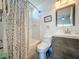 Updated bathroom with a shower and tub combination, modern sink, and stylish gray hexagon floor tiles at 2696 Hemingway Ave, Haines City, FL 33844