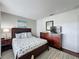 Bedroom featuring a wooden bed frame, dressers and TV, and patterned bedding and decor at 2696 Hemingway Ave, Haines City, FL 33844