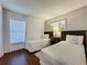 Bedroom with twin beds and accent wall with motorcycle art, plus a window with lots of natural light at 2696 Hemingway Ave, Haines City, FL 33844