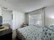 Bedroom features a window letting in light, a wardrobe closet, stylish decorations, and patterned bedding at 2696 Hemingway Ave, Haines City, FL 33844