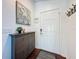 Welcoming entryway with modern decor, dark wood flooring, storage cabinet, and a secure front door at 2696 Hemingway Ave, Haines City, FL 33844