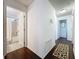 Hallway showing dark laminate wood floors and doorways to the bedrooms and bathrooms in the home at 2696 Hemingway Ave, Haines City, FL 33844