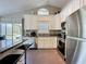 Modern kitchen featuring stainless steel appliances, granite counters, and an island with bar seating at 2696 Hemingway Ave, Haines City, FL 33844
