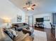 Comfortable living room with hardwood floors, cozy seating, and a ceiling fan, designed for relaxation at 2696 Hemingway Ave, Haines City, FL 33844