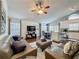 Spacious living area with hardwood floors, inviting seating, and a TV setup, perfect for relaxing at 2696 Hemingway Ave, Haines City, FL 33844