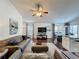 Cozy living room with hardwood floors, comfortable seating, and a ceiling fan for added comfort at 2696 Hemingway Ave, Haines City, FL 33844