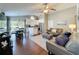 Open-concept living space featuring wood floors, neutral tones, modern furnishings, and ample natural light at 2696 Hemingway Ave, Haines City, FL 33844