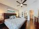 Cozy main bedroom with hardwood floors, ceiling fan, and ensuite bathroom and closet at 2696 Hemingway Ave, Haines City, FL 33844