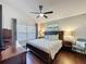 Cozy main bedroom with hardwood floors, ceiling fan, and neutral paint at 2696 Hemingway Ave, Haines City, FL 33844