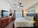 Spacious main bedroom featuring hardwood floors, ceiling fan, and neutral decor at 2696 Hemingway Ave, Haines City, FL 33844