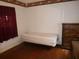 Cozy bedroom featuring a decorative border, with hardwood floors, a twin bed, and dresser at 302 S Palm Ave, Frostproof, FL 33843