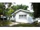 Delightful home features a tidy lawn and classic architectural details with ample natural light at 302 S Palm Ave, Frostproof, FL 33843