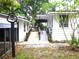 Charming home featuring a ramp for accessibility and well-maintained exterior landscaping at 302 S Palm Ave, Frostproof, FL 33843