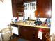 Efficient kitchen with dark wood cabinetry and neutral countertops at 302 S Palm Ave, Frostproof, FL 33843