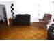 Spacious living room featuring neutral walls and parquet wood flooring at 302 S Palm Ave, Frostproof, FL 33843