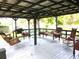 Charming covered patio with a swing and an assortment of comfortable seating options at 302 S Palm Ave, Frostproof, FL 33843