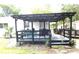 Inviting covered patio with outdoor furniture and a swing, perfect for relaxation at 302 S Palm Ave, Frostproof, FL 33843