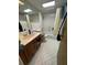 Modest bathroom with shower-tub combination, a single sink vanity and ceramic tile flooring at 400 W 4Th Ct, Frostproof, FL 33843