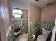 Bathroom featuring green tile and open shower at 400 W 4Th Ct, Frostproof, FL 33843
