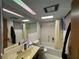 Simple bathroom featuring tiled floors, a tub-shower combo, and essential amenities at 400 W 4Th Ct, Frostproof, FL 33843