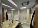 Functional bathroom with tiled floors, a tub-shower combo, and ample counter space at 400 W 4Th Ct, Frostproof, FL 33843