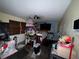 Cluttered bedroom featuring a ceiling fan and an array of personal items at 400 W 4Th Ct, Frostproof, FL 33843