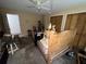 Bedroom featuring a wooden bed frame, closet with wooden doors, and ceiling fan at 400 W 4Th Ct, Frostproof, FL 33843
