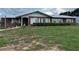 Charming brick home with a metal roof and well-maintained lawn at 400 W 4Th Ct, Frostproof, FL 33843