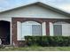 Close-up of the brick exterior with white-framed windows at 400 W 4Th Ct, Frostproof, FL 33843
