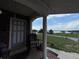 Inviting front porch offering a serene view of the nearby lake at 400 W 4Th Ct, Frostproof, FL 33843