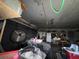 Cluttered garage with a garage door, shelving, and a mix of stored items at 400 W 4Th Ct, Frostproof, FL 33843