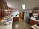 Open kitchen with wood cabinetry, neutral countertops, and modern appliances, perfect for cooking at 400 W 4Th Ct, Frostproof, FL 33843