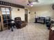 Spacious living room with tile flooring, featuring a ceiling fan at 400 W 4Th Ct, Frostproof, FL 33843