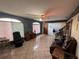 Bright living room featuring tile floors, ceiling fan, and natural light at 400 W 4Th Ct, Frostproof, FL 33843