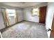 Bright bedroom features ample natural light and neutral carpeting at 405 S Shore Dr, Eagle Lake, FL 33839