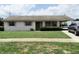 Charming single-story home featuring a well-maintained lawn and covered parking at 405 S Shore Dr, Eagle Lake, FL 33839