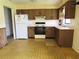 Functional kitchen boasts classic cabinets, appliances, and practical layout at 405 S Shore Dr, Eagle Lake, FL 33839