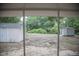 Backyard featuring two sheds, trees, and foliage as seen from a screened porch at 4725 Kayworth Rd, Lake Wales, FL 33898