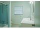 Cozy bathroom with blue shower, white sink vanity, and natural light at 4725 Kayworth Rd, Lake Wales, FL 33898