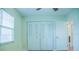 Neutral bedroom featuring a large window, double closet and ceiling fan at 4725 Kayworth Rd, Lake Wales, FL 33898