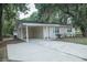 Front exterior showcasing a covered parking area and well-maintained lawn at 4725 Kayworth Rd, Lake Wales, FL 33898