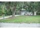 View of the house with a cozy, welcoming front lawn with trees at 4725 Kayworth Rd, Lake Wales, FL 33898