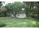 View of the home framed by lush trees and greenery, showcasing its serene setting at 4725 Kayworth Rd, Lake Wales, FL 33898