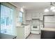 Bright kitchen offering white cabinets, new appliances, and access to the enclosed back patio at 4725 Kayworth Rd, Lake Wales, FL 33898