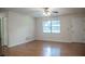 Inviting living room with wood floors, a large window and closet space at 4725 Kayworth Rd, Lake Wales, FL 33898