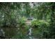 A serene pond view and home surrounded by lush greenery at 4725 Kayworth Rd, Lake Wales, FL 33898