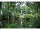 A serene pond reflects a home and lush greenery at 4725 Kayworth Rd, Lake Wales, FL 33898