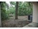 View of the grassy backyard and new AC unit at 4725 Kayworth Rd, Lake Wales, FL 33898