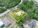 Aerial view of the property, showcasing the home's layout, landscaping, and surrounding greenery at 509 Mountain Dr, Babson Park, FL 33827