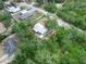 Aerial shot of a home nestled among lush trees in a residential area, showcasing its metal roof at 509 Mountain Dr, Babson Park, FL 33827